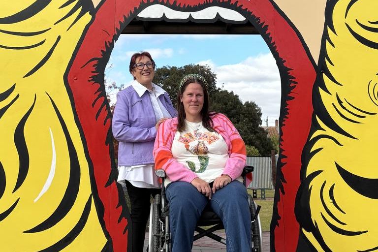Dimboola's milliner Pauline Thomson with Allira Roberts under the newly constructed mouth gateway at Tower Park.