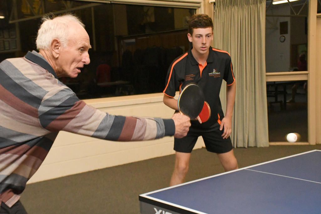 Graeme Koschitzke makes a backhand return as playing partner Will Martin watches on.