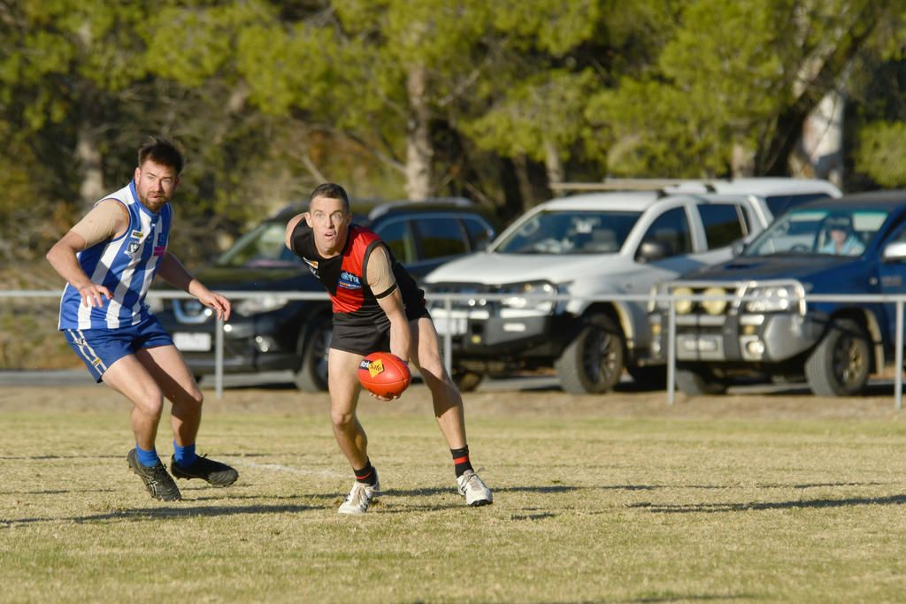 Noradjuha Quantong's Leigh Stewart looks to handball.