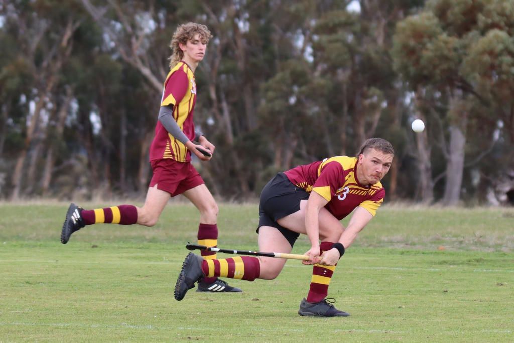 Warrack Hoops&rsquo; defender Hamish Wagenknecht clears the ball out of defence with teammate Ben Williamson in support.