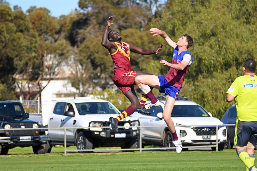 Warrack Eagles' Machok Garang battles Demons' Rhys Barber in the ruck during the round 16 clash in Brim.