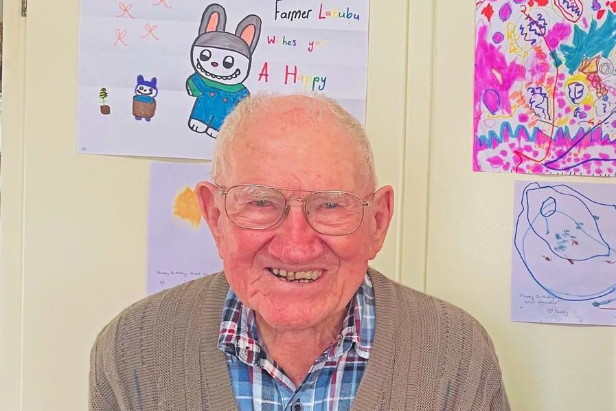 Former farmer and WWII pilot Ian McRae of Dimboola turns 103, seen here with hand drawn greetings from some of his great-grandchildren.