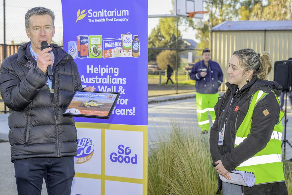 Horsham Special School principal Ben Tait receiving an appreciation award from Variety Bash official Piper Butcher.