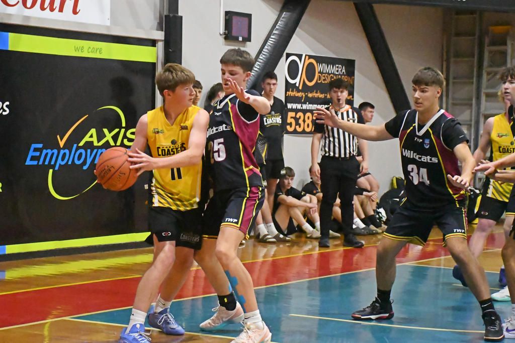 Warracknabeal's Campbell Mansfield applies tight defence on Portland's Patrick Impey during the Wildcats' 10 point grand final win at the Horsham Intersport Junior Classic Basketball Tournament on Sunday, November 9.