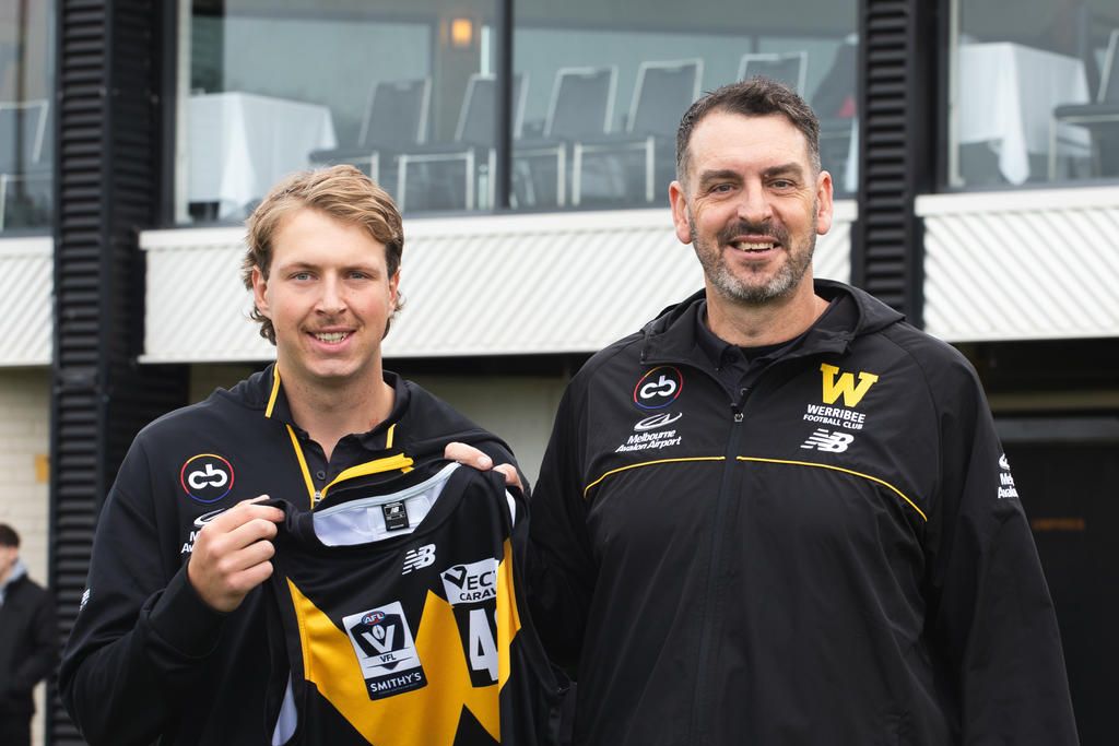 Cody Bryan receives his jumper from Werribee's ruck coach, Peter Street.