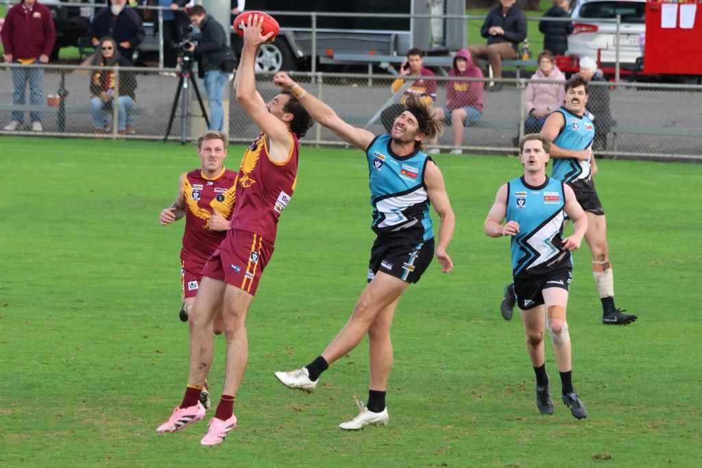 Tim Jorgensen marks in front of Simon Clugston.