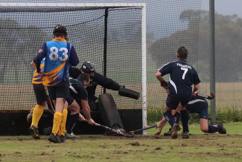 Some desperate defending has Nhill Rangers’ goalkeeper Henry Gill taking on several Yanac Tigers as they attempt to score off a penalty corner.