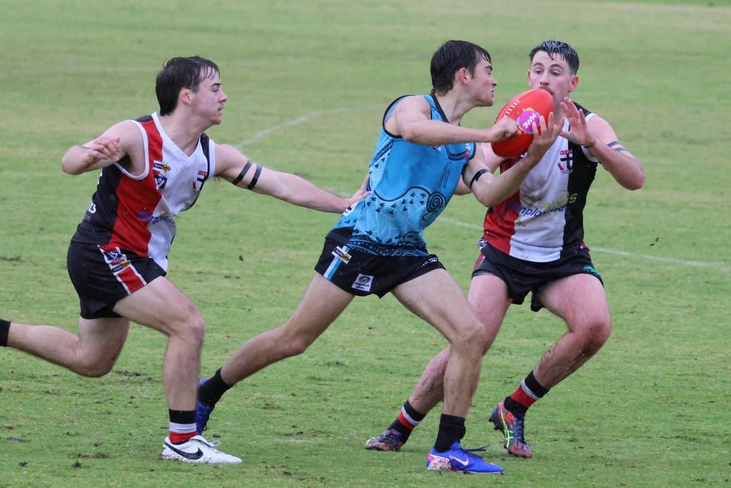 Ryder Gould attempts to get a handball away.