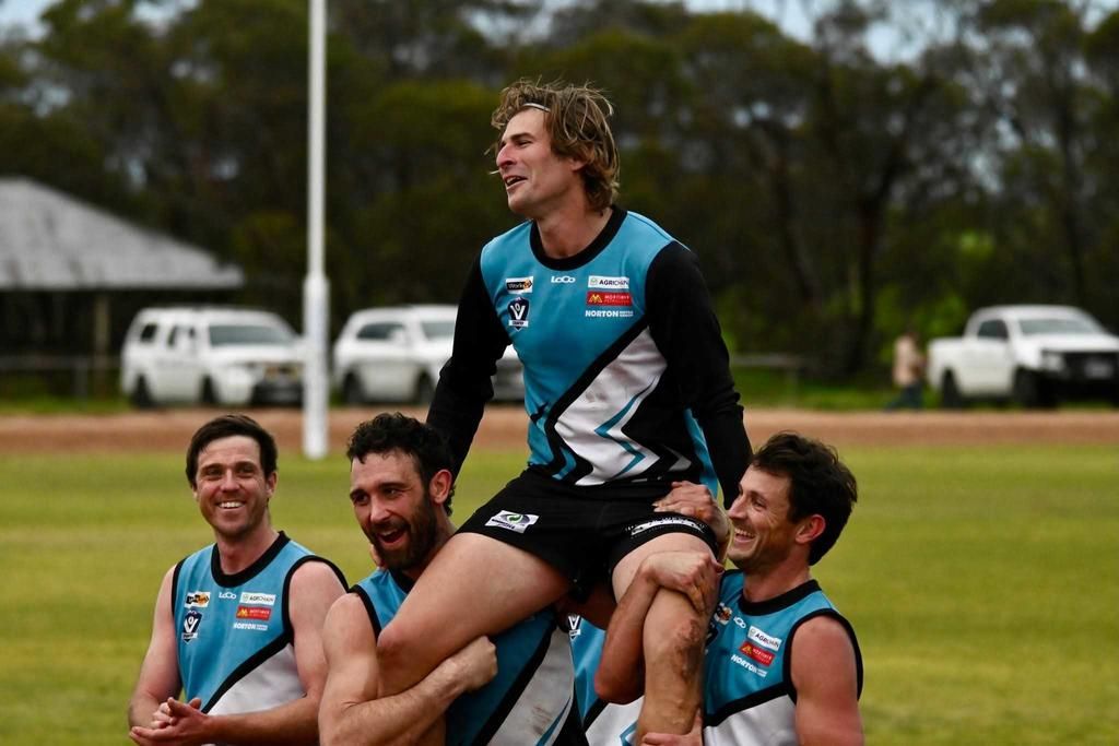 Simon Clugston is chaired off the ground.
