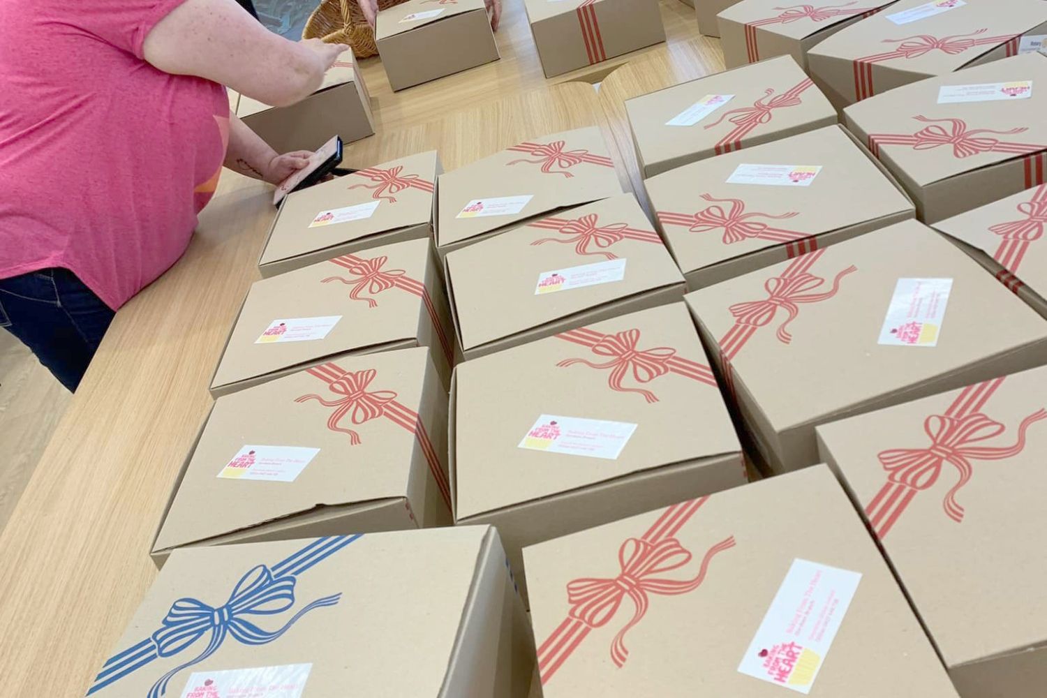 Volunteers from Baking from the Heart pack goodies for delivery.