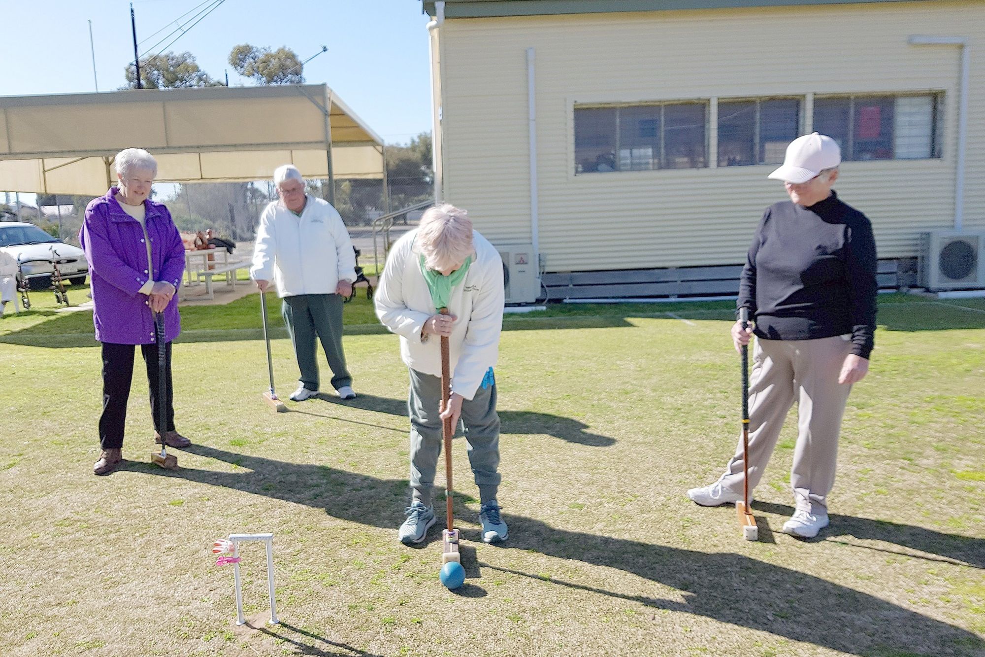 Janet Donnelly lining up her shot for the hoop watched closely by Val Elbourne & Sandra Hinch from Quontong & John Moar from Dimboola.