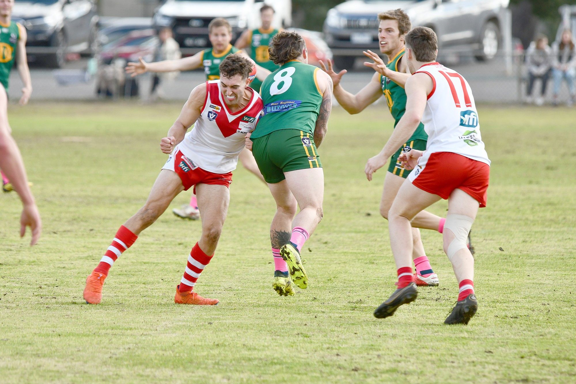 Dimboola coach Jack Landt handpassed to team-mate Ben Miller as Ararat's Tom Williamson applies pressure on Saturday.