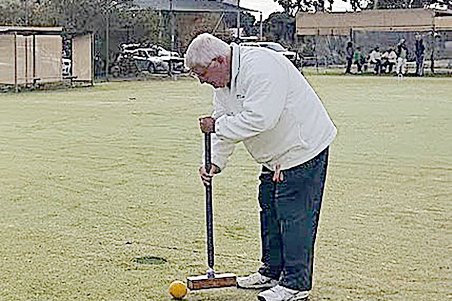 John Moar lining up the yellow ball for a shot at the hoop.
