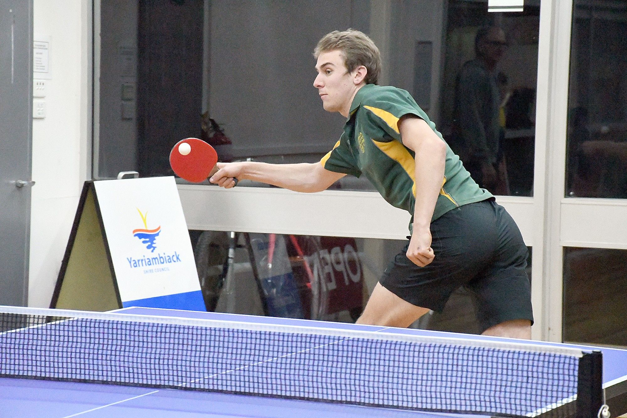 Wheat's Sandon Schultz stretches to make a forehand return.