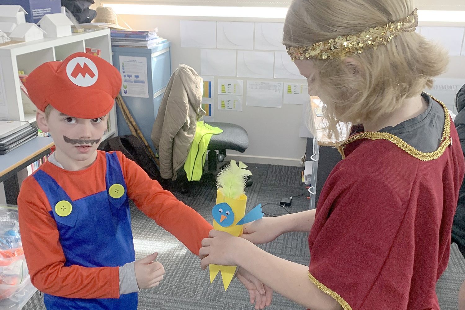 Ollie dressed as "Mario" getting assistance from his Grade 6 buddy Evan, dressed as a Roman. They are making a bird puppet from the book Bev and Kev.