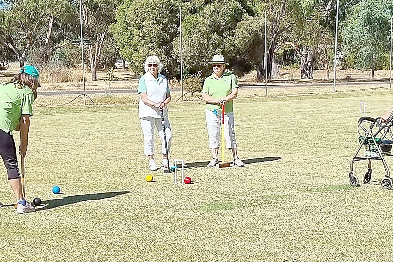 Laurel Holding prepares to make a hoop watched by Jean Bourke, Kelly Walker and Jan Post.