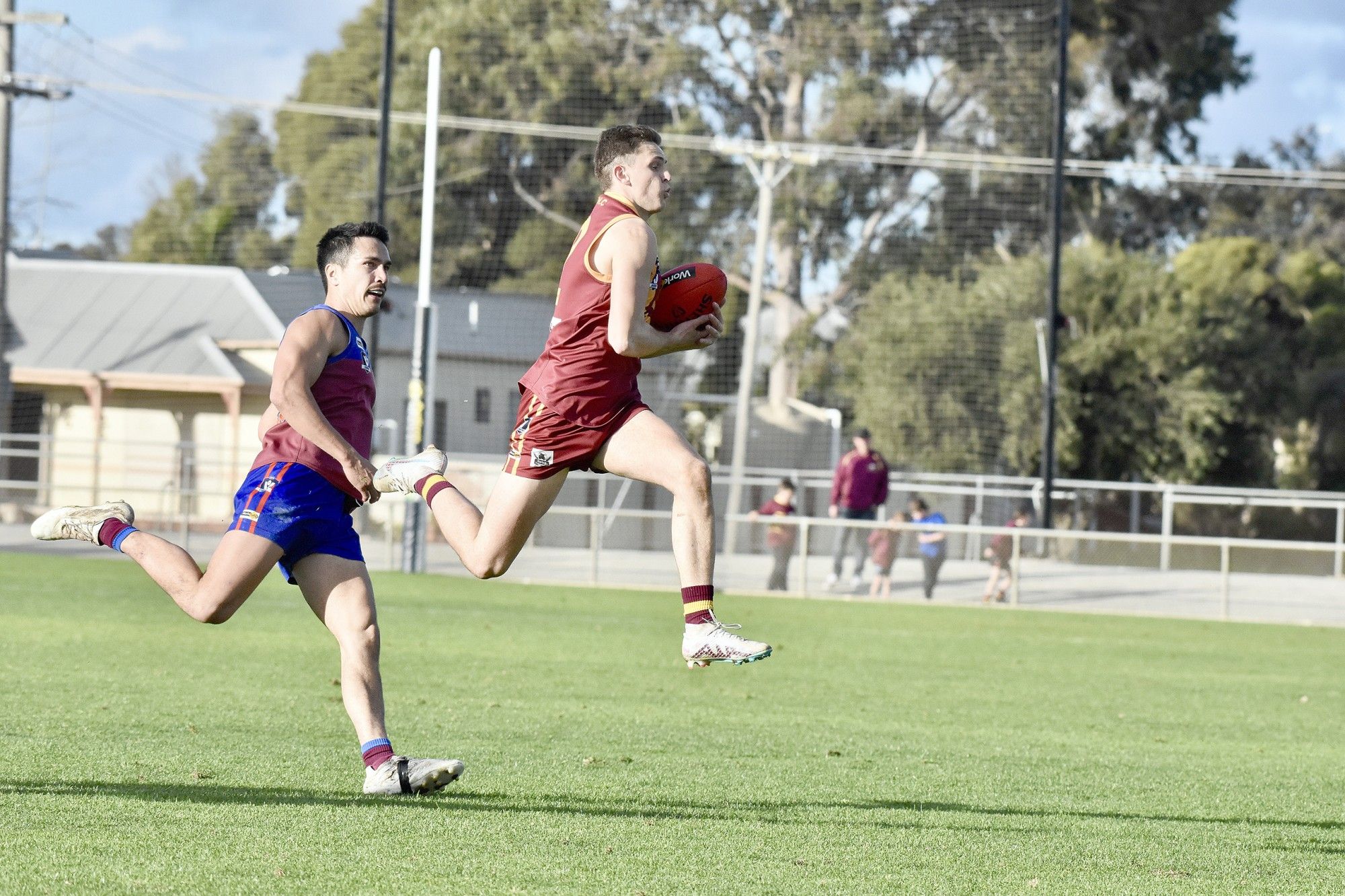 Warrack Eagles defender Sean McKenzie clutches the ball to mark in front of Horsham coach Tyler Blake during Saturday's clash at Anzac Park.