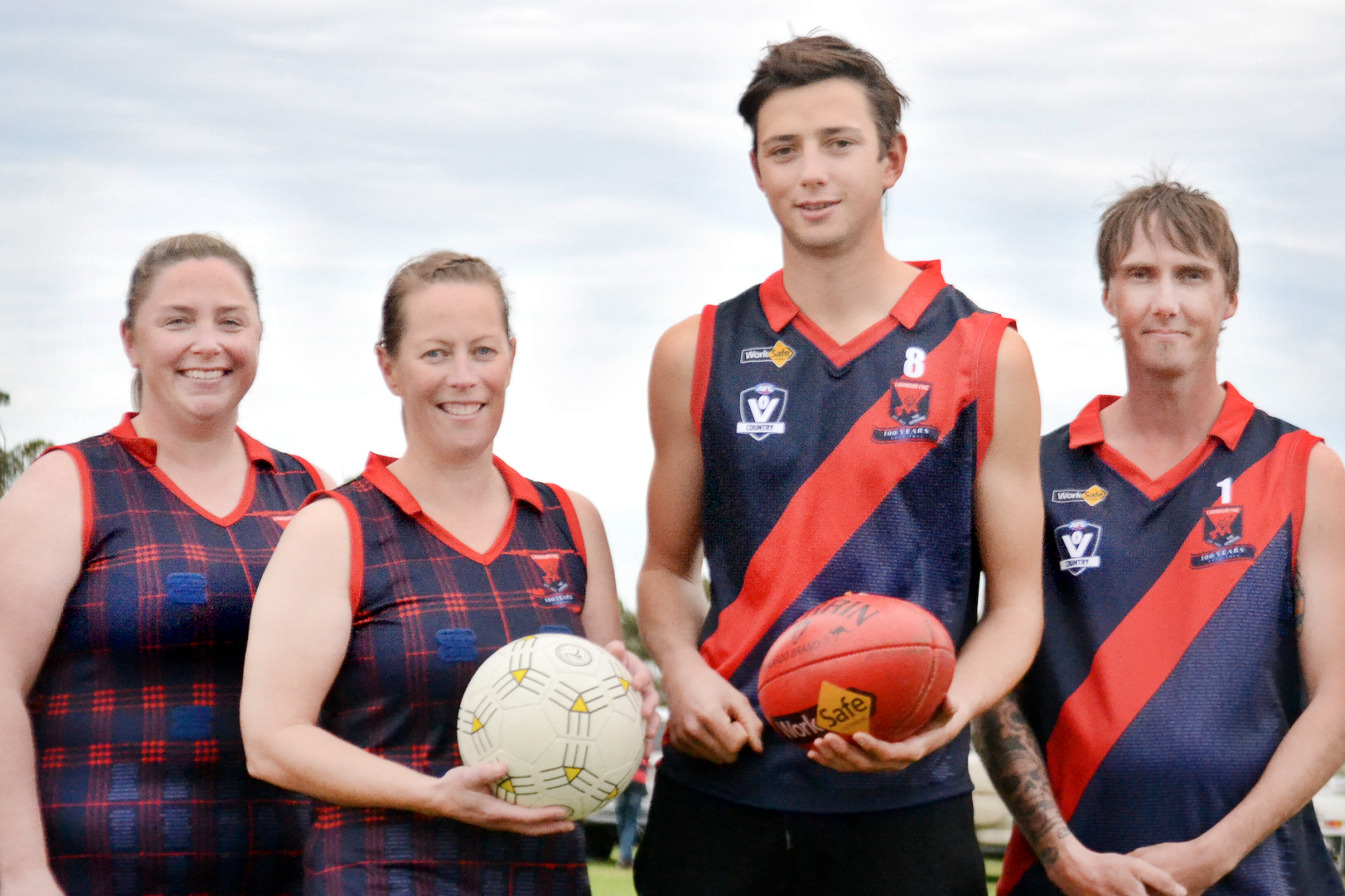 Laharum Football and Netball Club players Hayley Roberts, Shannon Arnott, Ollie Skyes and Brad Hately in the club's 100th anniversary heritage jumpers.