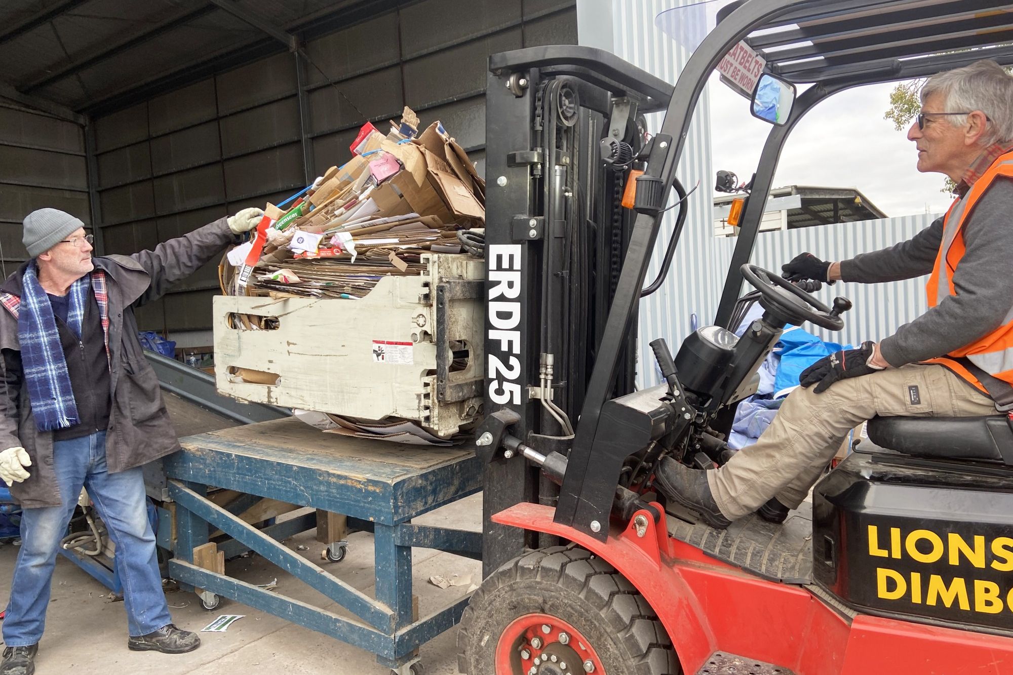 Lions Club members Brian Boyce and Leo Devaan (driving) rounding up donated cardboard at the Lion's depot on Hindmarsh Street