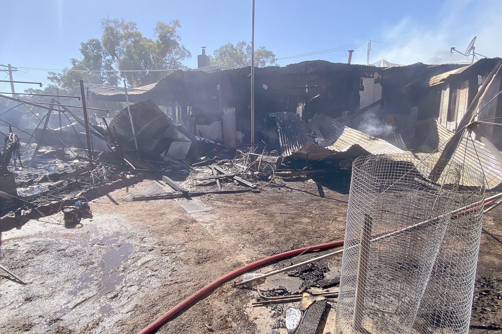 The backyard, which had a number of cars, boxes, gas bottles, spray cans, fuel containers and equipment was also engulfed by the fire.