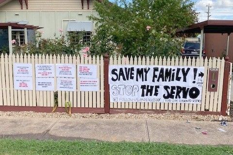 Protest banners which were outside the home of John McKee (inset).