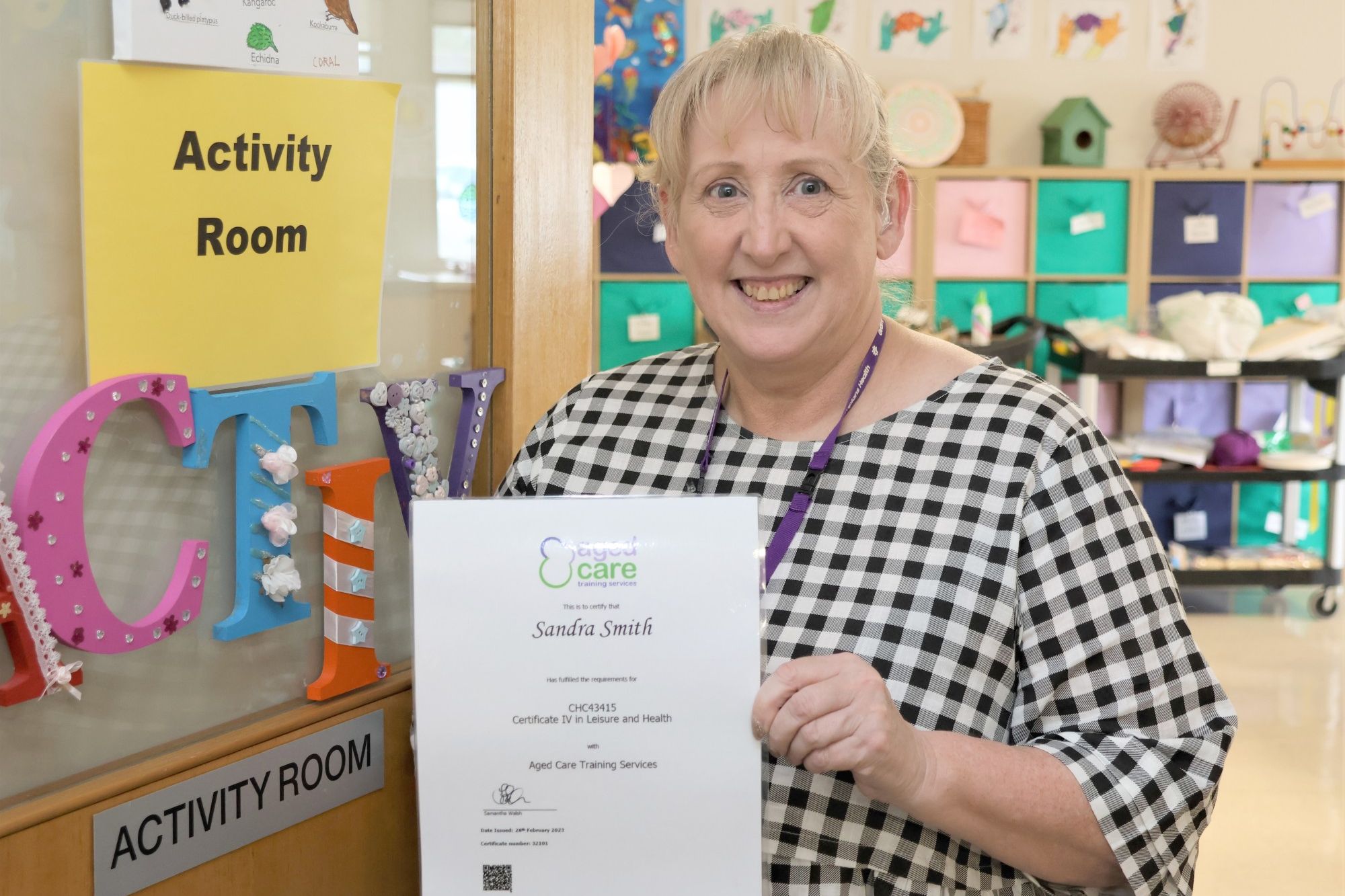 A delighted Sandra Smith poses with her Certificate in Leisure and Health.