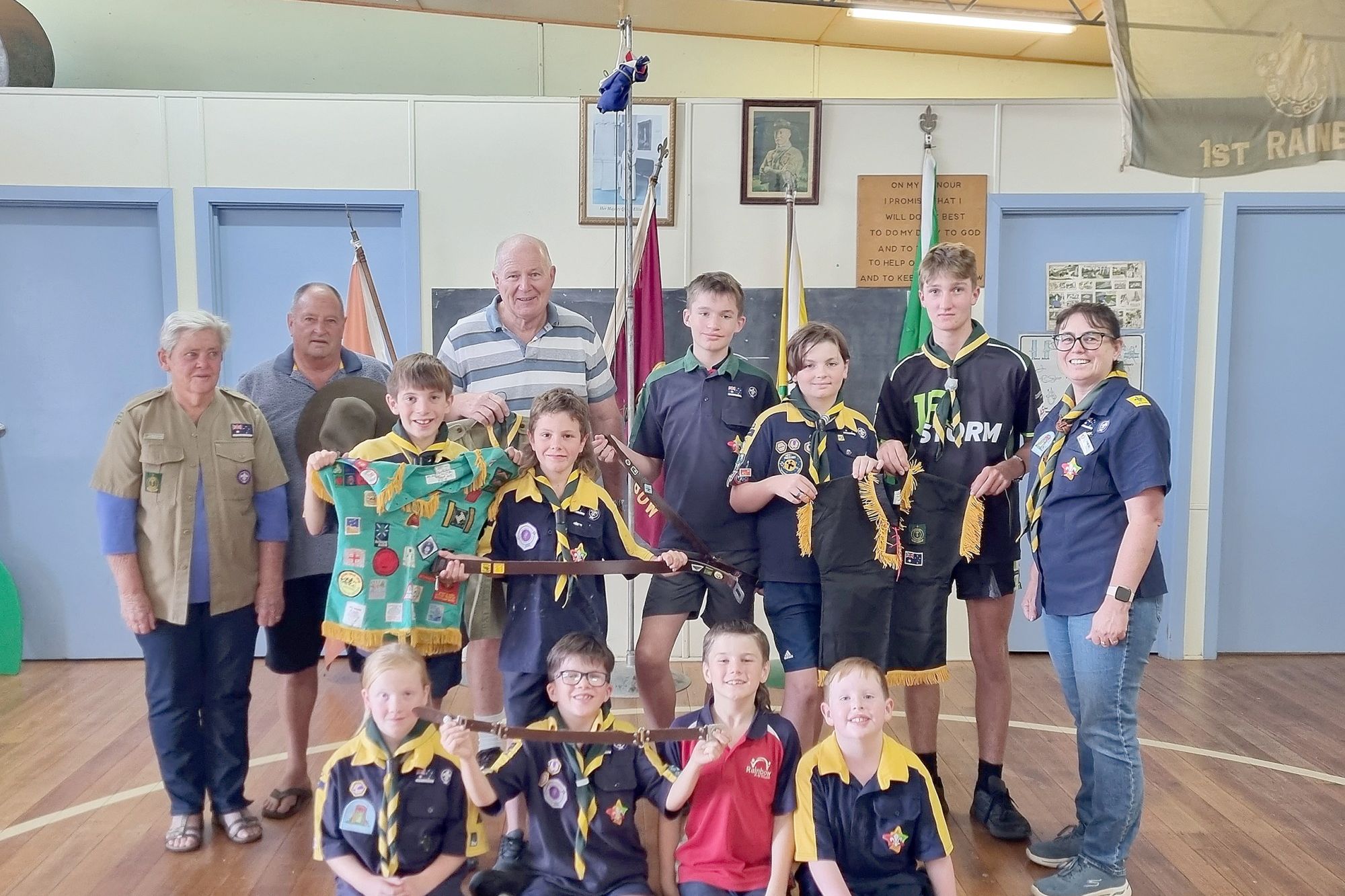 The 2023 Rainbow Scout Group with past members. Back, left to right: Marg Mellington, Danny Gould, Peter Solly, Jasper Bigham, Edison Stasinowsky, Parker Gould, Claire "Akela" Roll. Middle: Tyler Webb, Murphy Jochinke. Seated: Adalyn Clugston, Kolby Bigham, Tanner Bigham, Noah Heinrich.