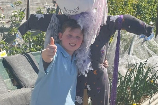 Braxton Chandler and Miss Onesie are ready to scare away pests this Halloween