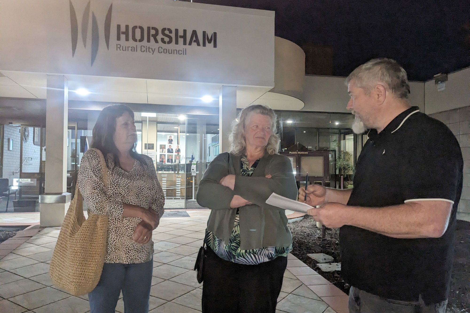 Parking meter critics Anna Hawkins and Kath Dumesny speak with Terry O'Donnell after Monday night's meeting.