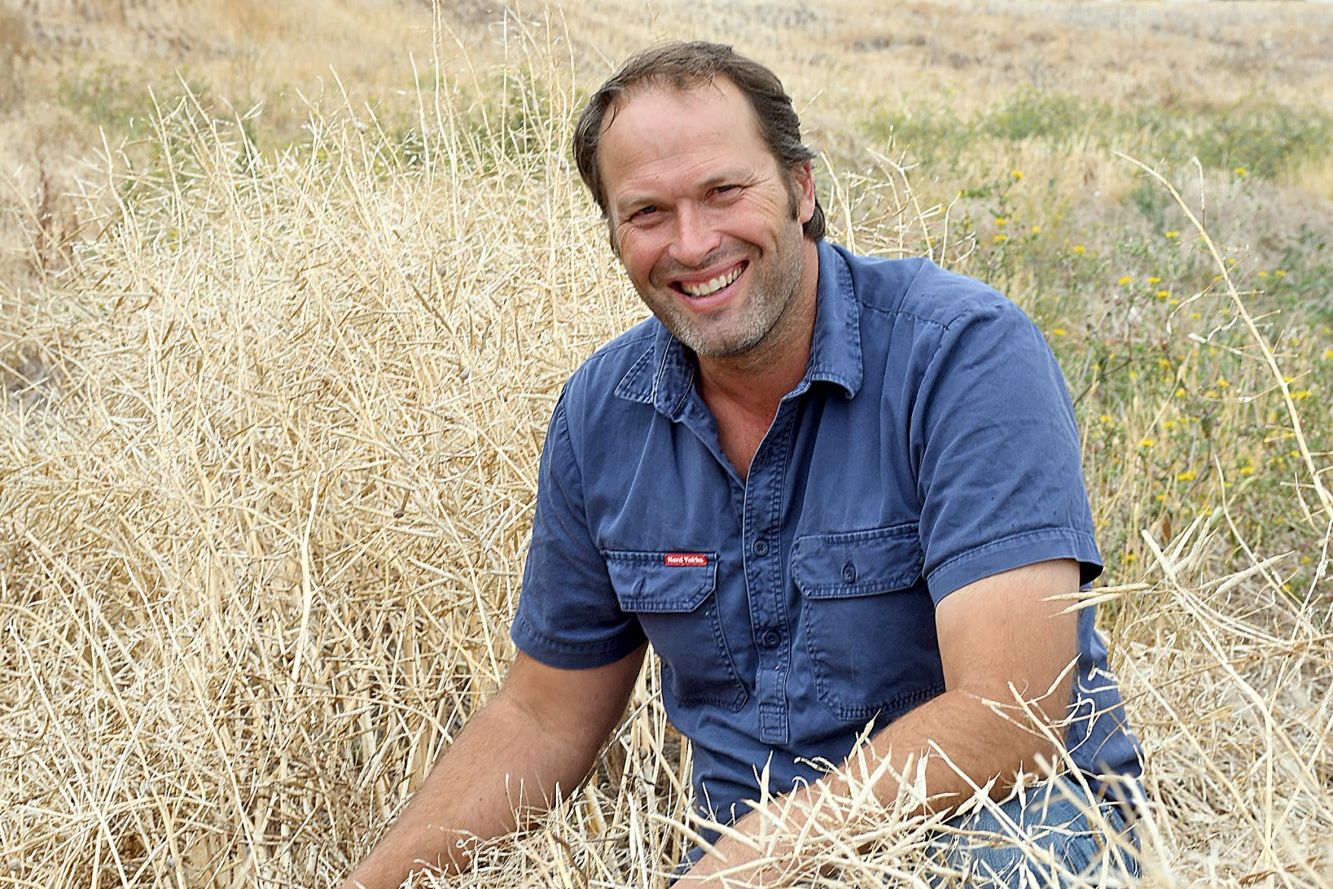 GREAT TIME: Murra Warra farmer and vice president of the National Farmers Federation, David Jochinke stands in some remaining crop, unable to be harvested due to extremely soft ground. Many farmers still have standing crop left in paddocks due to the risk of headers being bogged. But just the same, he says it&rsquo;s a great time to be in agriculture.