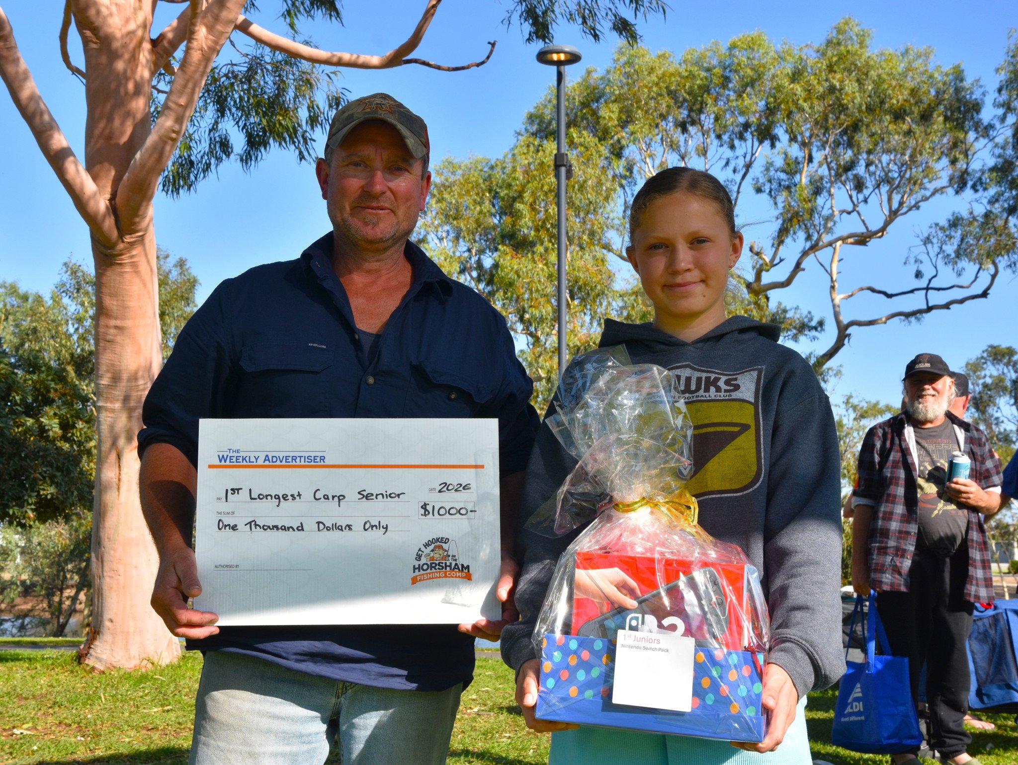 Father Barry Matulick with daughter Alana with their respective prizes. Barry took out the Senior Longest Carp, while Alana won the Longest Junior Native category.