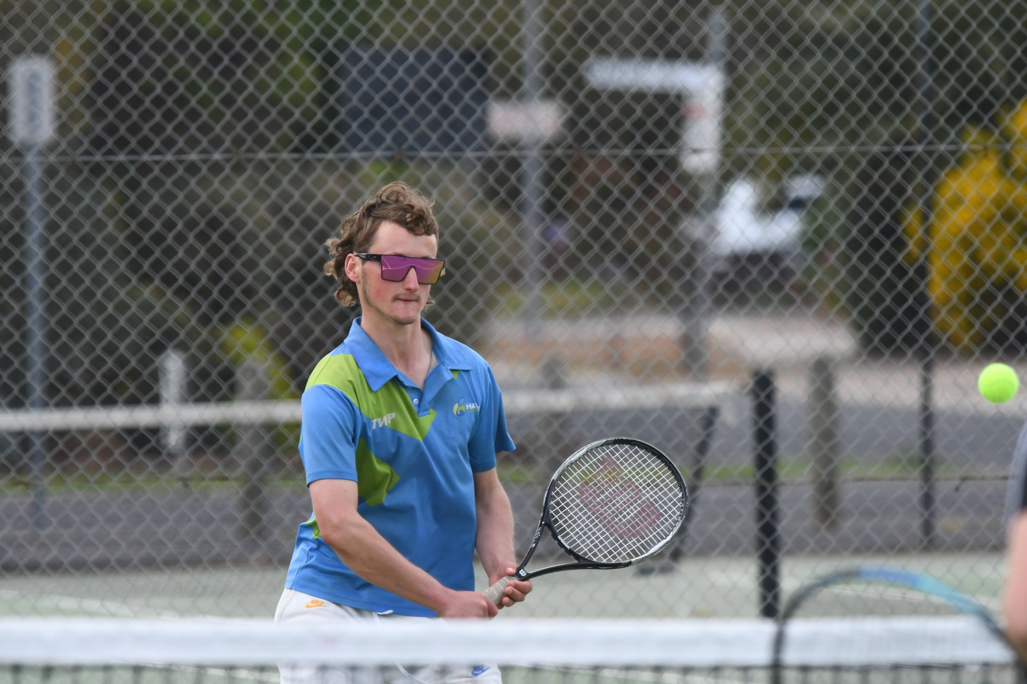 Haven's Thomas Mott prepares a backhand volley in a B special doubles rubber against Central Park.