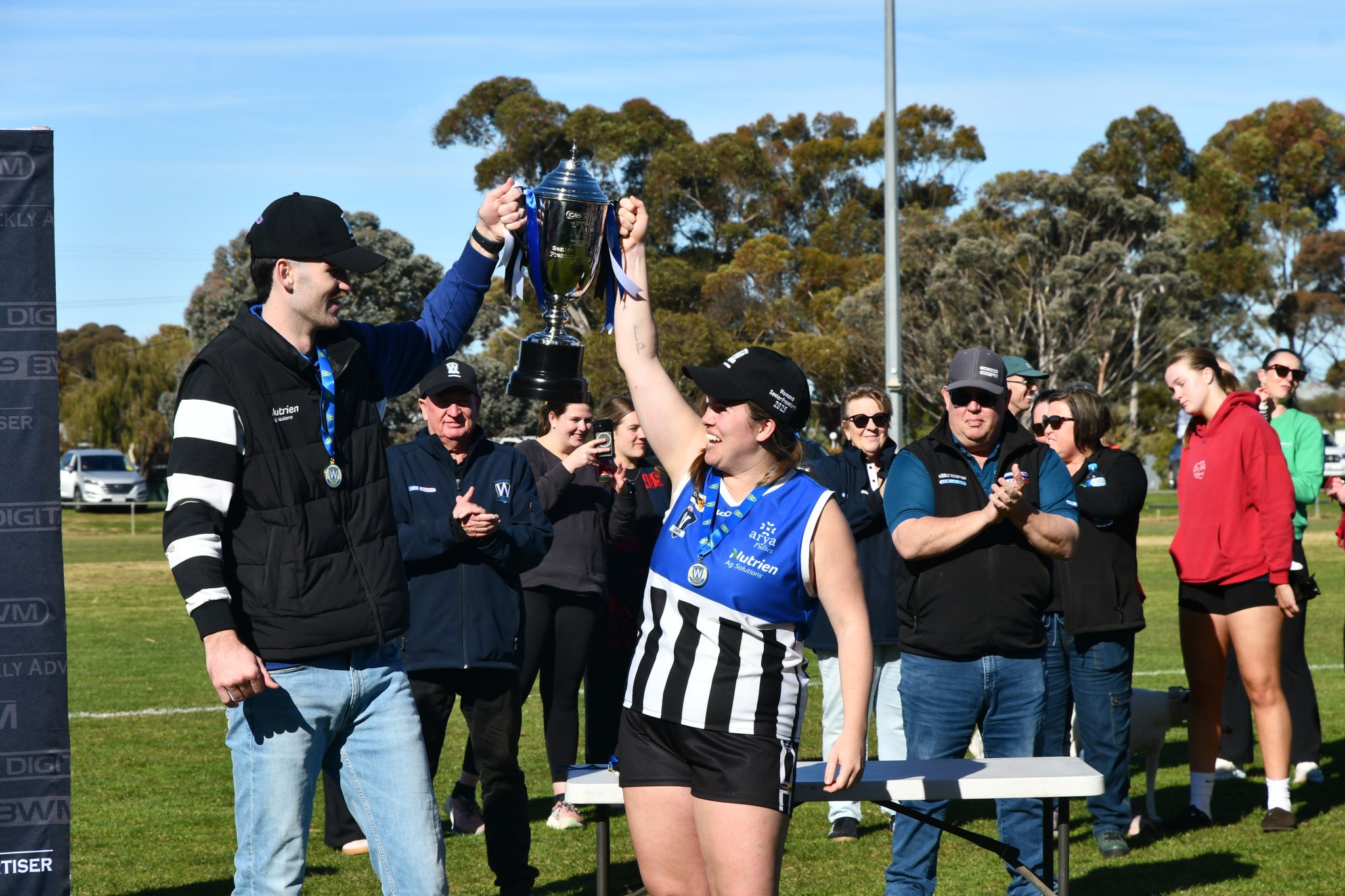 Minyip Murtoa coach Nick Cushing and captain Tegan Kerrins lift the premiership cup.