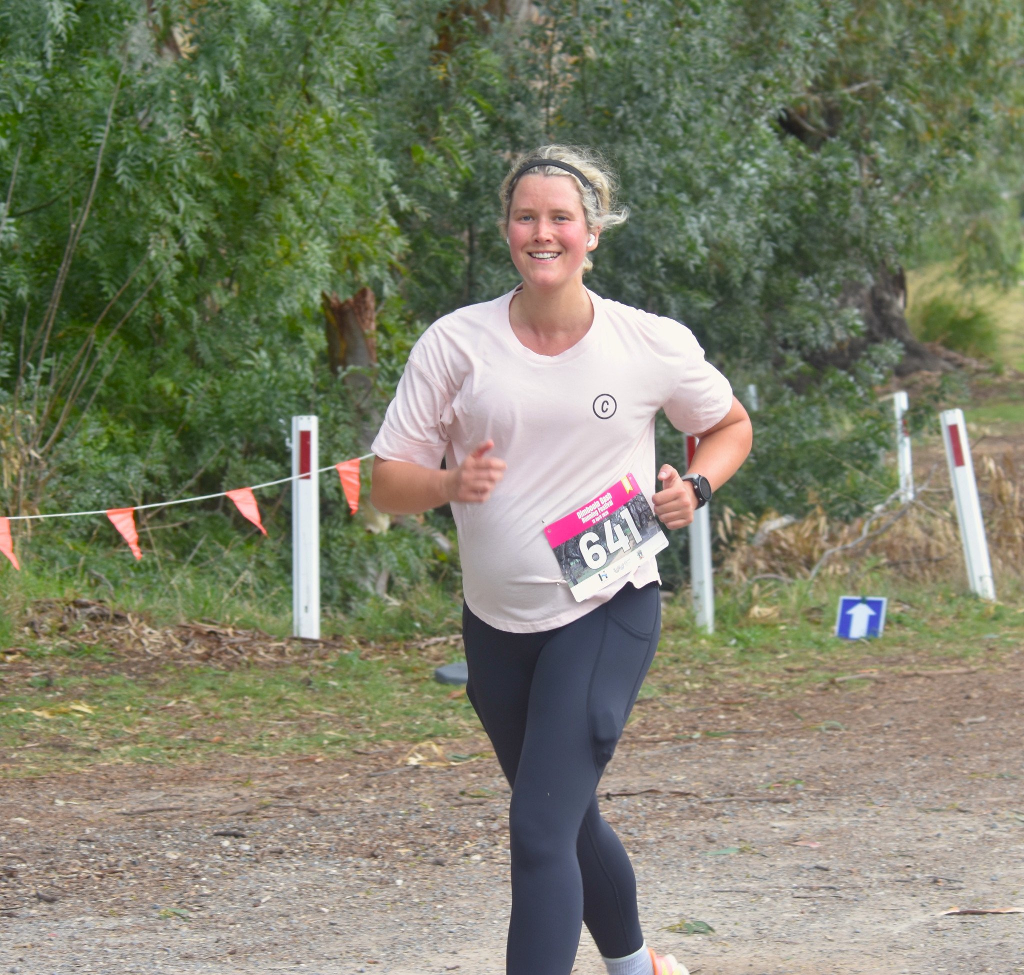 Emma Ulrick is in high spirits as she approaches the finish line of the 5km.