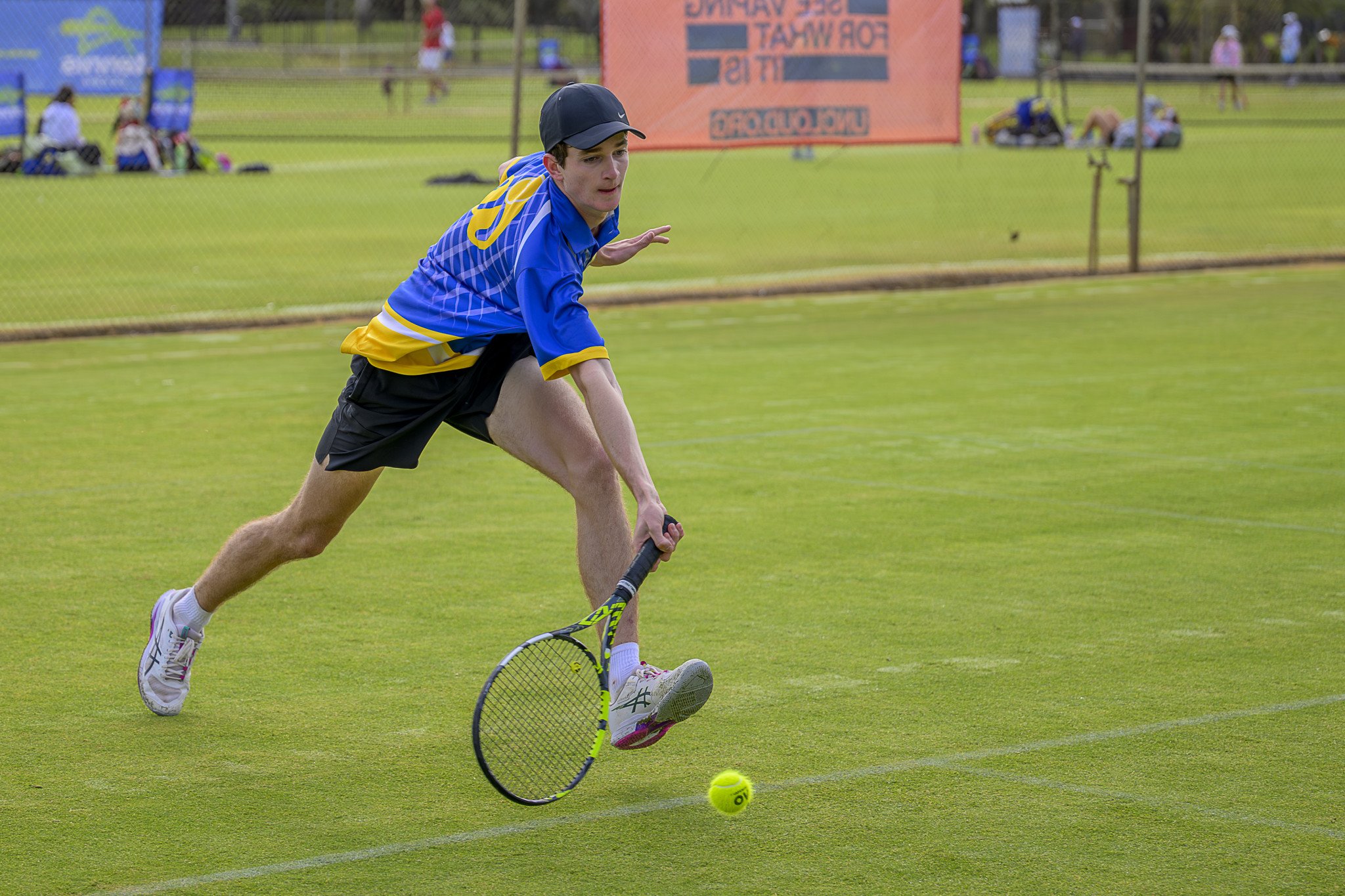 Harry Allan lunges forward for the return.