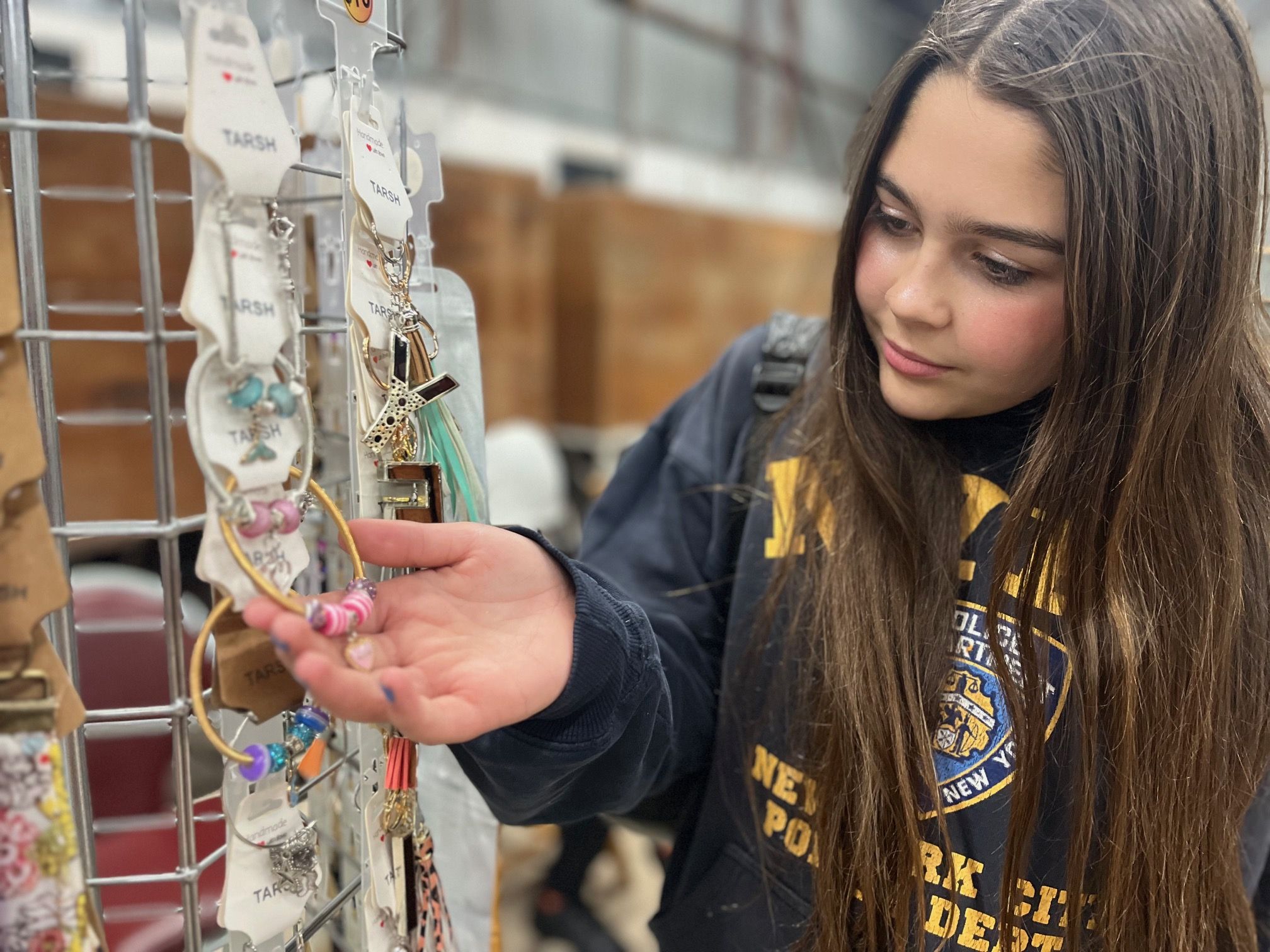 Twelve-year-old Anora Corbett looks at the range of creations at Tarsh.