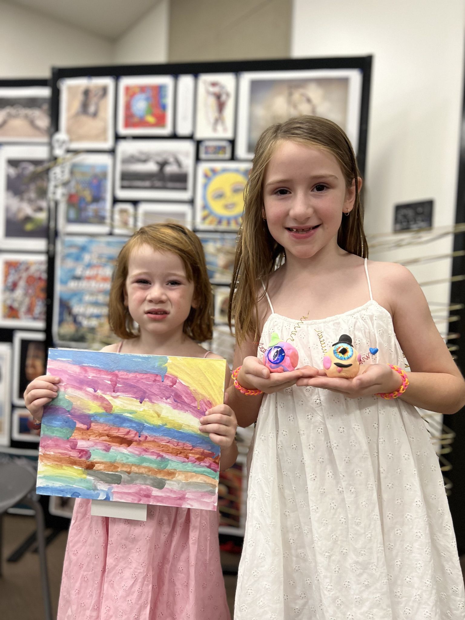Eldie, 5 and Matilda, 7, showing off their painting and monsters.