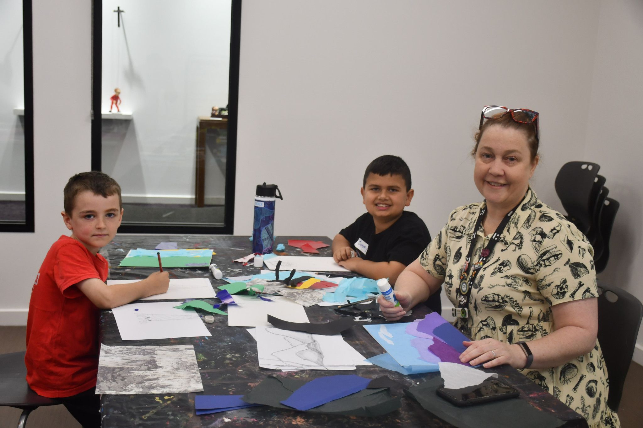 Xaviey, 7 and Jimmy, 7, are learning from the Horsham Town Hall public art officer, Larissa Riddell.