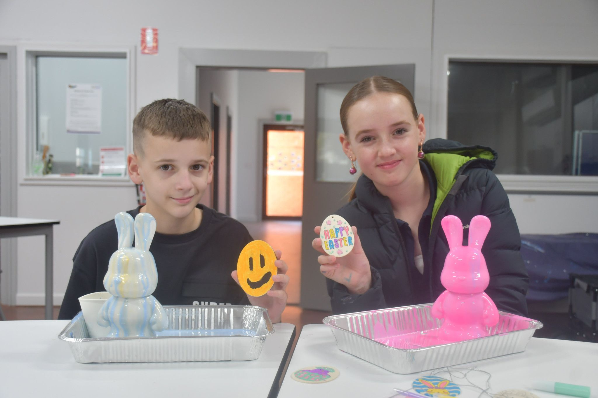 Siblings Angus, 10 and Mahli, 12, making a marble-painted bunny at 'The Station' during Easter craft activity.