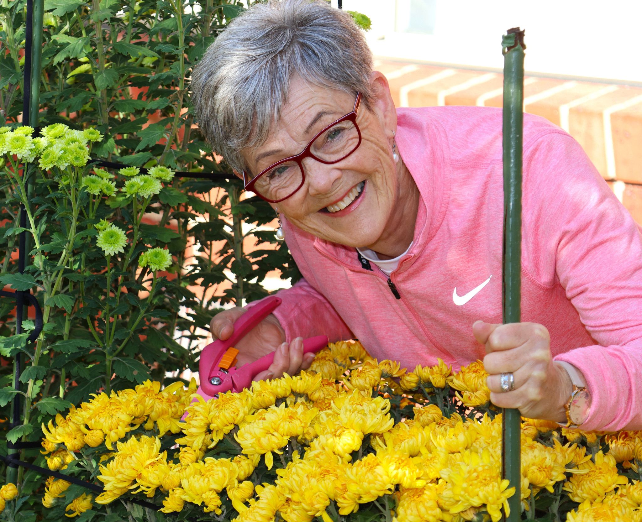 Lea Crammond gathering flowers from a garden. Photo: GRAMPIANS HEALTH