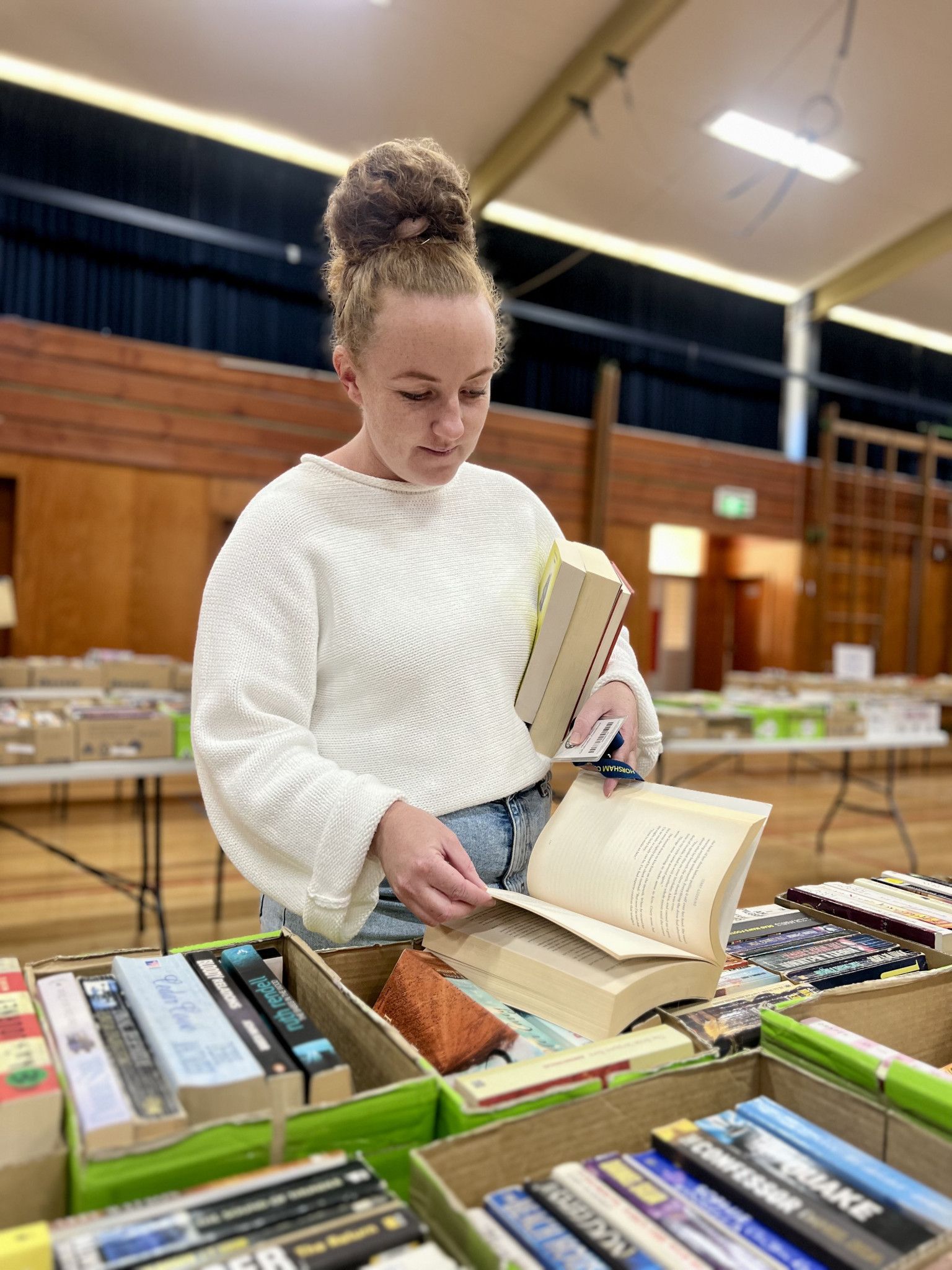 Jess Hogan browsed different books at the fair to find the best one to read.