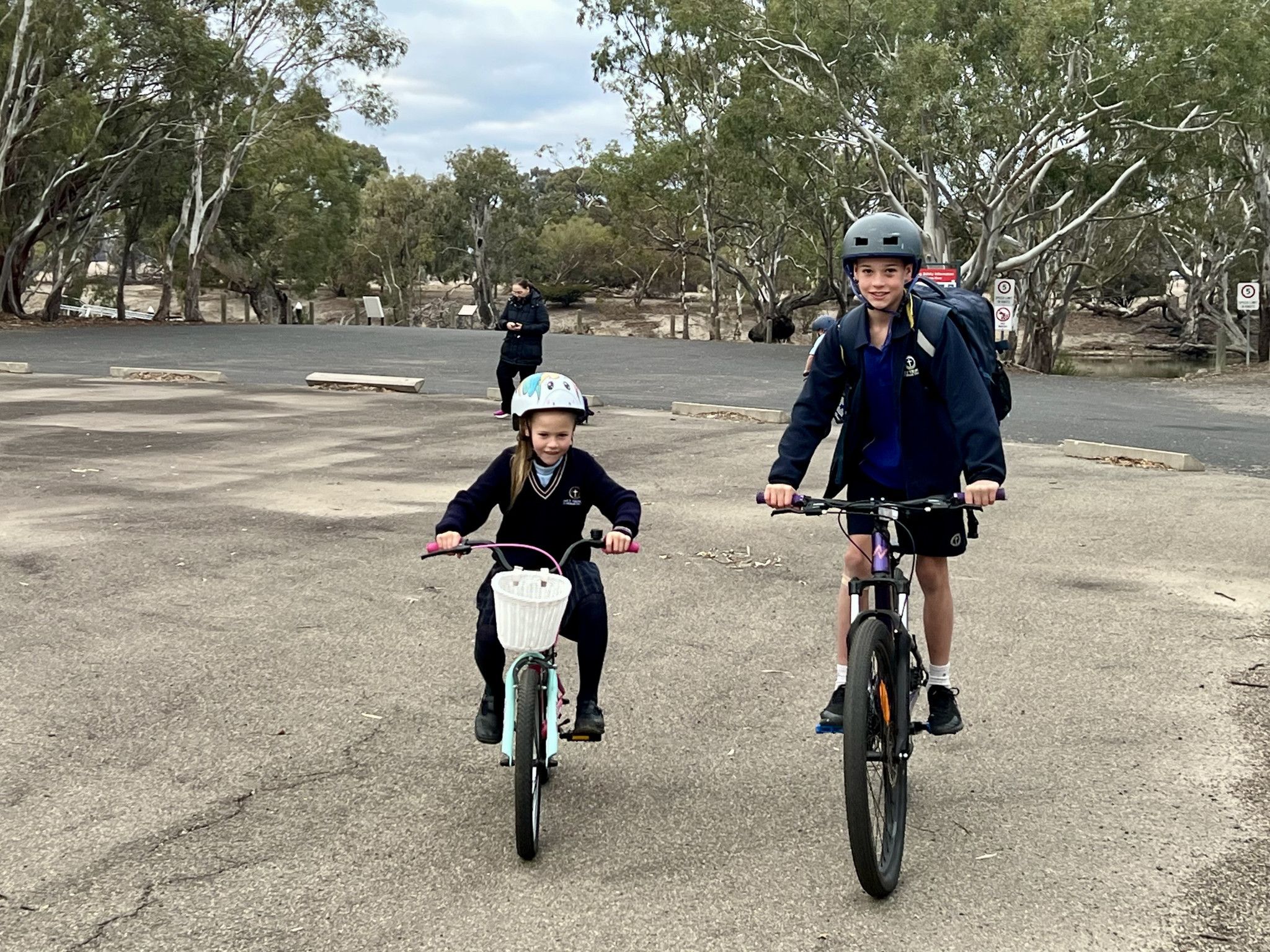 Siblings Vinnie, 7, and Jaxon, 9, ride their bikes to school.