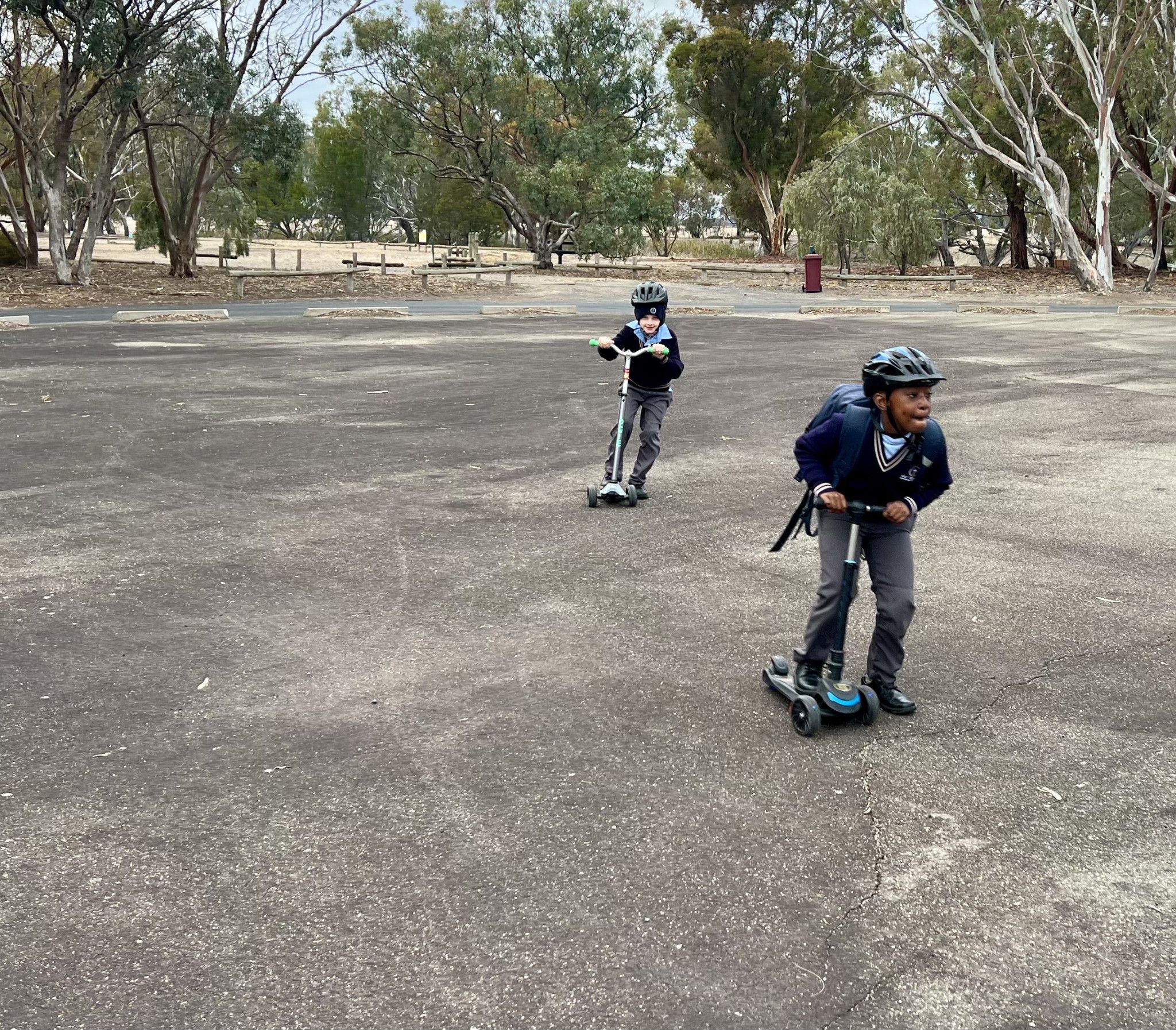 Eddie, 7 and Nkanyzi,7, riding their scooties at the helipad.