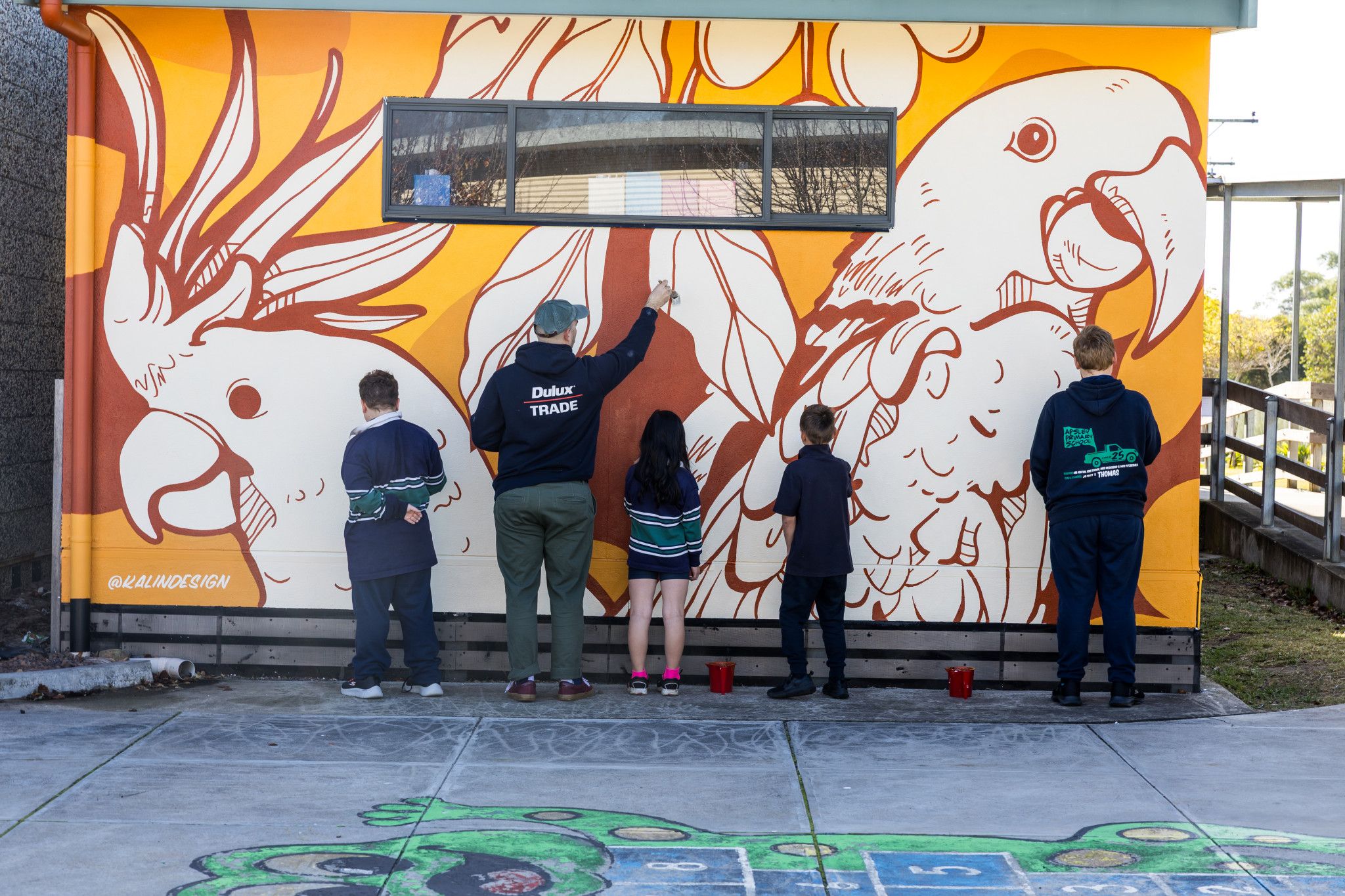 The entire school helped renowned muralist Philip Kalinowski complete the mural in just two weeks.