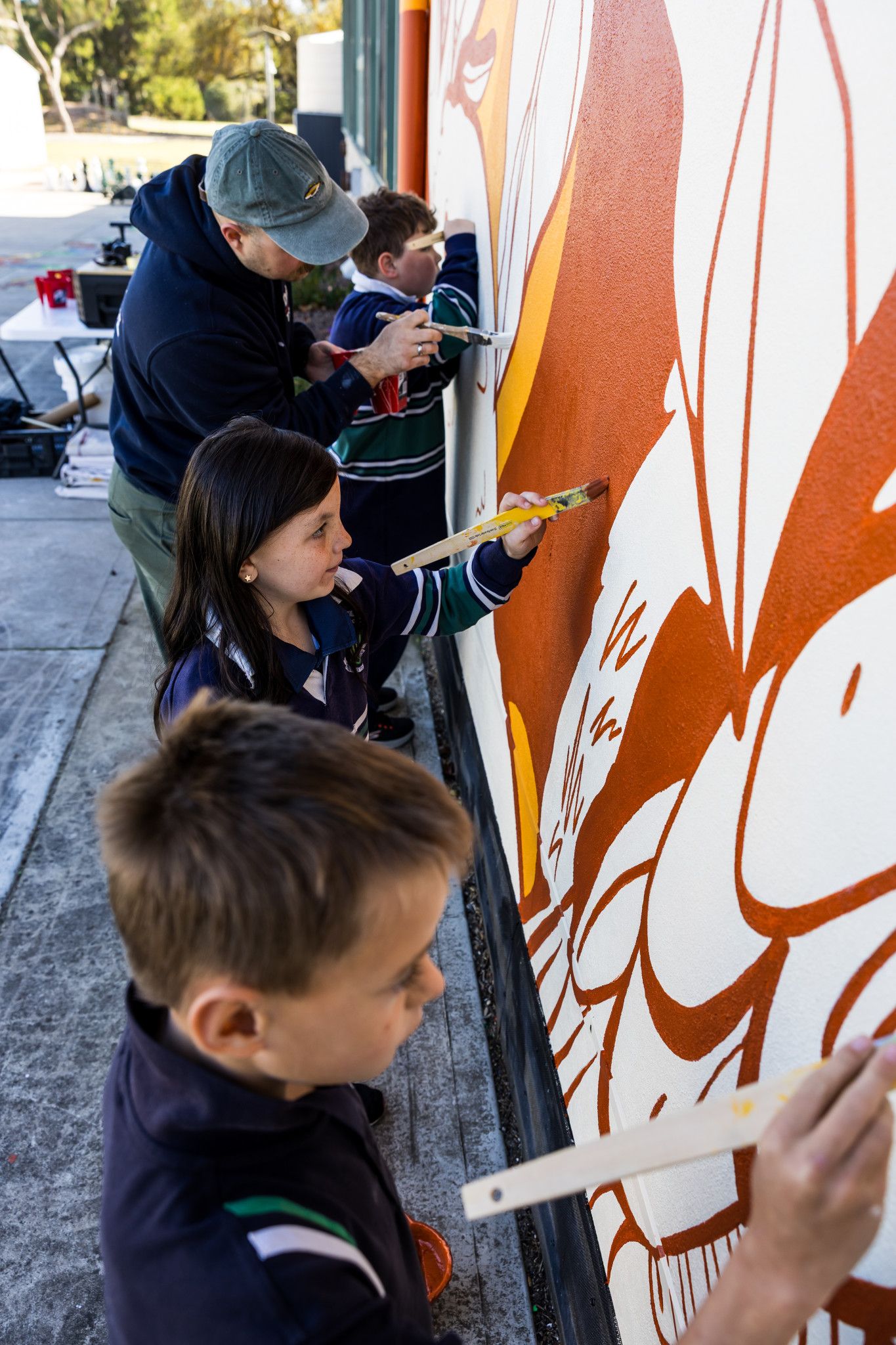 The entire school helped renowned muralist Philip Kalinowski complete the mural in just two weeks.