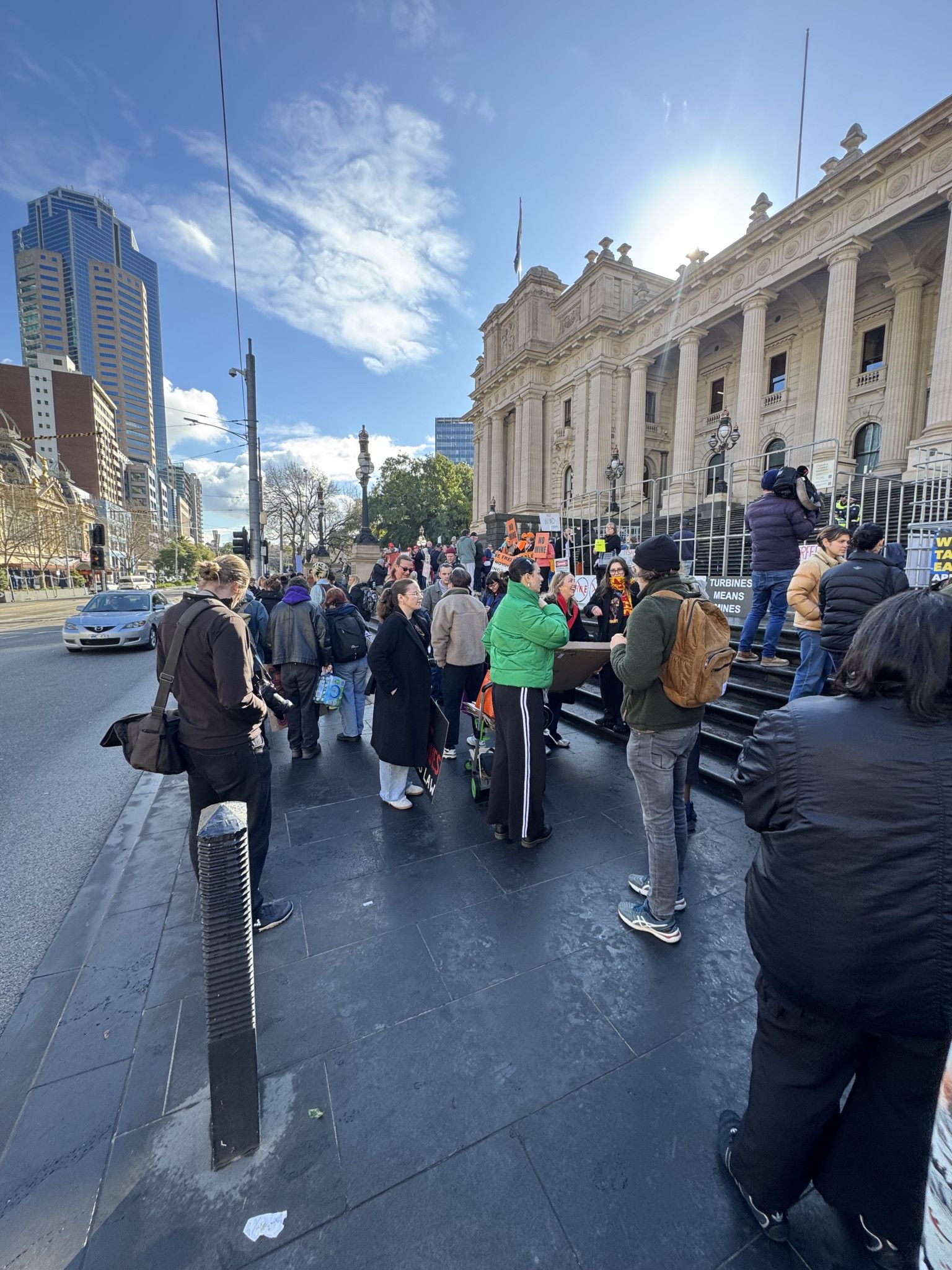 Early morning crowd and media descend on Parliament House steps to rally for land access rights.