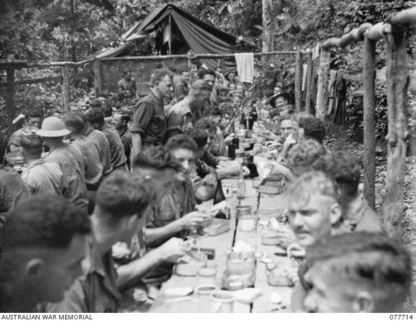 Troops of the 9th Infantry battalion enjoy a specially cooked festive meal on December 25, 1944 on Bougainville Island.