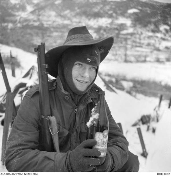 On January 1 1953 in Korea, Private Lawrence Charles (Larry) Hopson of Turramurra, NSW, and of D Company, 3rd Battalion, The Royal Australian Regiment, enjoys a bottle of beer from a Christmas parcel, despite the fact it's half frozen.