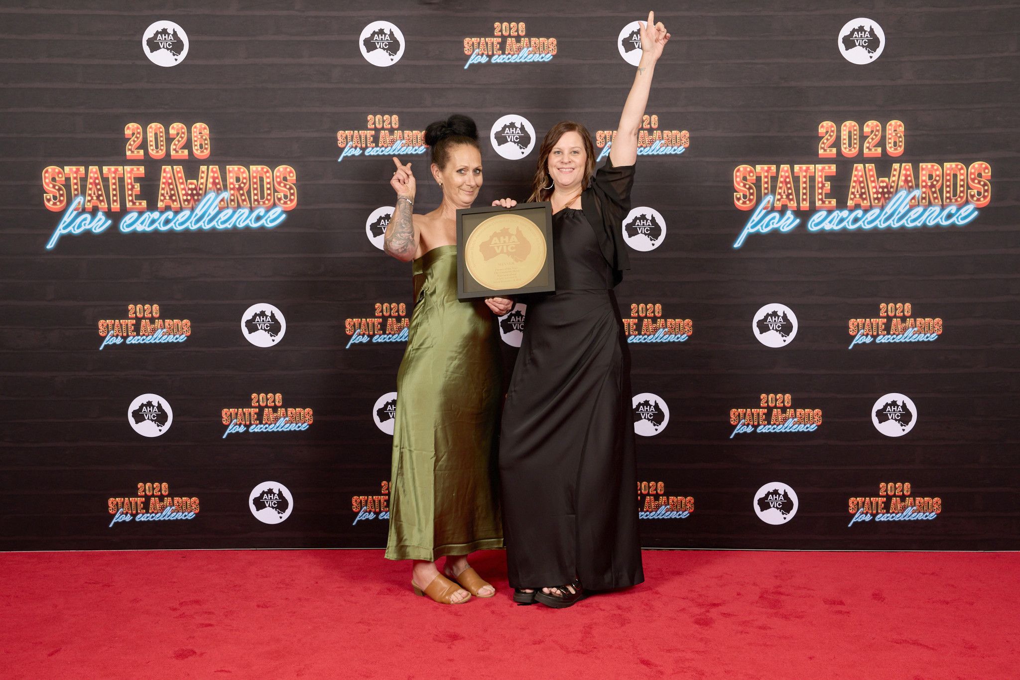 Creekside Hotel staff member Jacquelyn Devlyn and owner Skye Dubignon celebrate winning Parma of the Year at the AHA state awards.