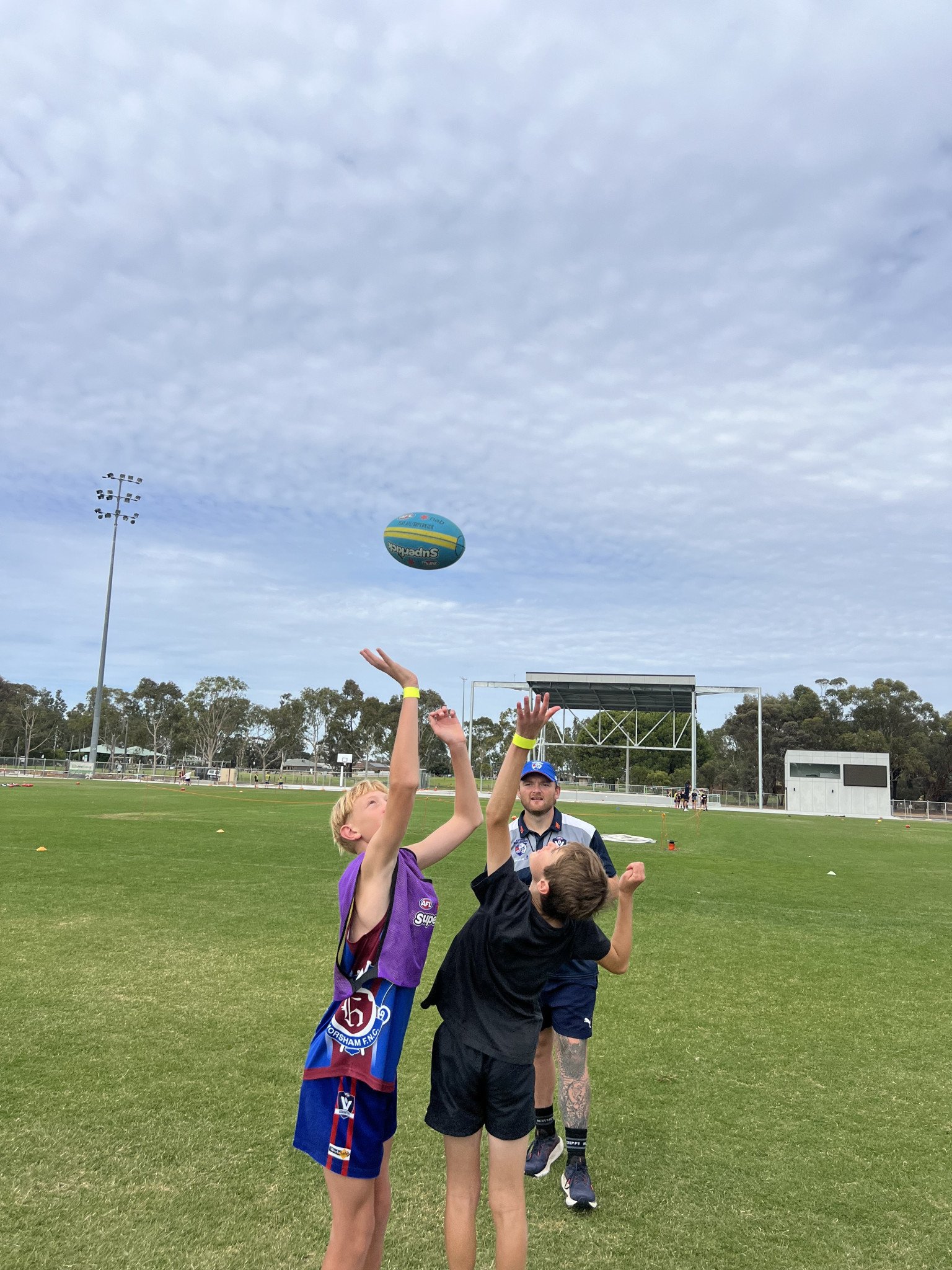 Murphy, 11 and Ryder, 10, are trying to grab the football at the start of the mini-match.